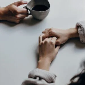 Two Hands on Table with Coffee