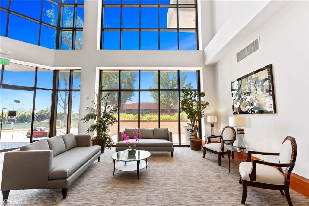 inside lobby waiting area of 600 N Rosemead Blvd in Pasadena, CA. Tall ceiling with many windows